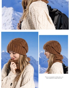 Close-up of brown cable-knit beanie and neck warmer set against a snowy mountain background