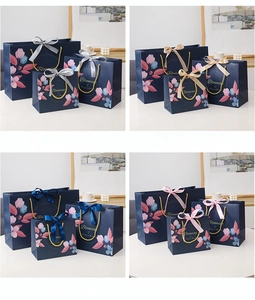 Floral gift bags in three sizes with gold Blooming text and colorful satin ribbons