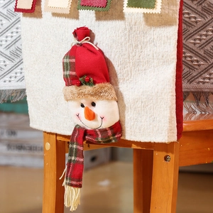 Detailed close-up of a festive 3D snowman chair cover with red knit and plaid scarf detail