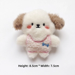Detail of plush dog brooch with pink striped vest and blue bone, 8.5cm by 7.5cm size