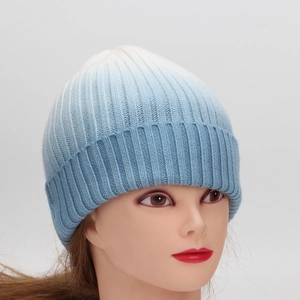 Women's blue and white tie-dye knit beanie with ribbed texture and folded cuff edge