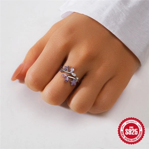 Elegant S925 sterling silver floral ring with purple crystals worn by a model