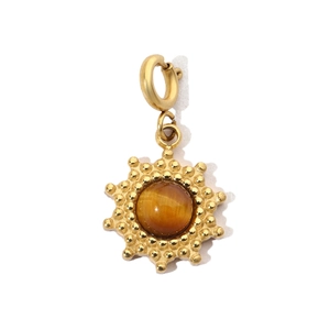 Detailed close-up of a golden sunburst pendant featuring a brown tiger eye gemstone center