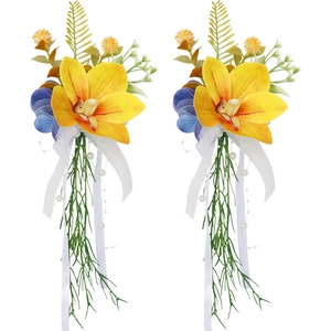 Wedding glass decoration featuring yellow orchids, blue petals, and white silk ribbons