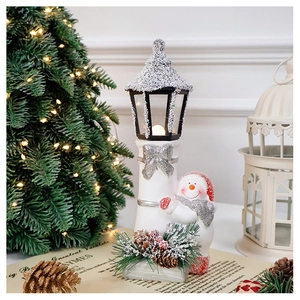 Close-up of a Christmas snowman street lamp decoration with warm glowing LED lights