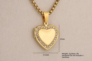 Detailed macro view of a heart-shaped gold locket with inlaid rhinestones, 21mm size