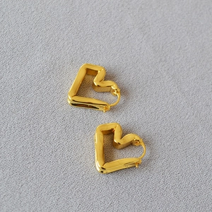 Minimalist gold plated brass heart earrings with irregular geometric design in mirror finish