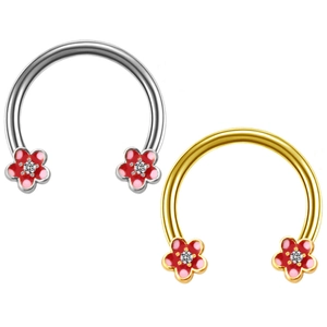 Detailed view of silver and gold horseshoe hoops with red floral crystal accents