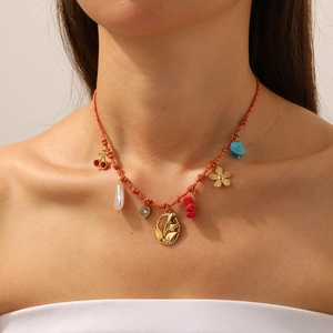 Handmade woven necklace with tulip, cherry pendants and pearls on a female model