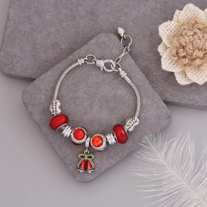 Detail of silver snake chain bracelet with red crystal beads and a heart Mum charm