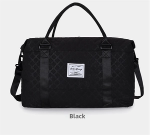Close-up of black quilted travel gym bag featuring diamond stitching and brand label