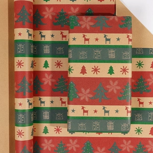 Close-up of vintage kraft Christmas wrapping paper rolls with festive deer and tree patterns