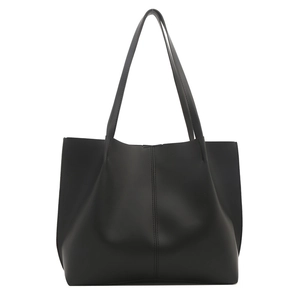 Minimalist black large capacity tote bag with central vertical seam and long shoulder straps