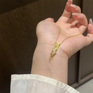 Detail of gold-plated wheat tassel necklace with sparkling cubic zirconia carvings