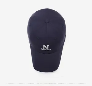 Top-down view of a navy blue baseball cap with white N embroidery and 6-panel crown detail