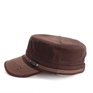 Close-up of vintage army cap with leather brim, star embroidery, and metal buckle detail