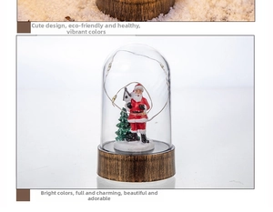 Detail of Santa Claus LED glass globe with mini Christmas tree and retro metal base