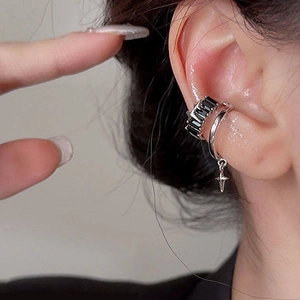 Silver star cross ear cuff with black zircon stones for non-pierced ears on a model