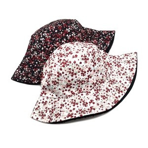 Women's floral reversible bucket hats in black and white styles for outdoor sun protection