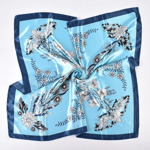 Detail of light blue floral satin square scarf with dark blue border and lily print