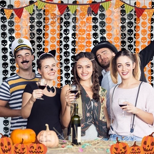 Halloween party fringe curtain backdrop with skull ornaments and orange bunting flags