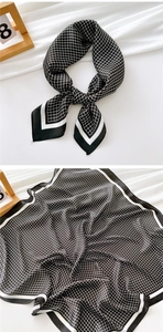 Detailed view of black and white checkered silk scarf with premium satin texture