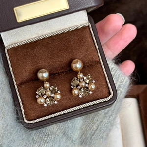 Elegant gold vintage flower earrings with pearls and amber crystals in a velvet jewelry box
