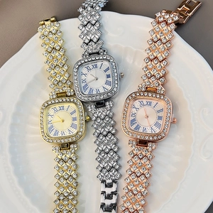 Detailed shot of three sparkling rhinestone-studded square watches in gold, silver, and rose gold