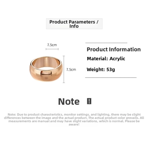 Detail of rose gold acrylic geometric bangle featuring 7.5cm width and faceted surface