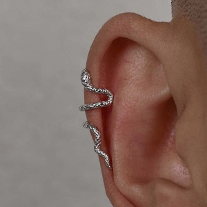 Macro detail of silver double-layered snake ear cuff with textured scale pattern on ear