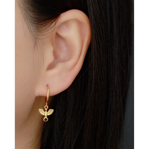 Gold S925 sterling silver hoop earrings featuring a bird pendant with a black gemstone