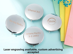 Close-up of polished silver pocket mirrors with custom laser engraved names and patterns