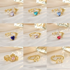 Collection of golden rings with colorful heart gems and sparkling crown design