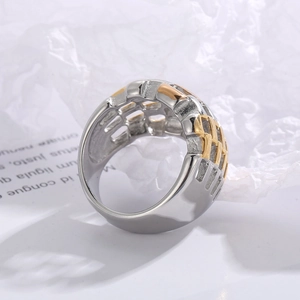Detail of wide two-tone mixed metal ring featuring a mesh hollow weave design