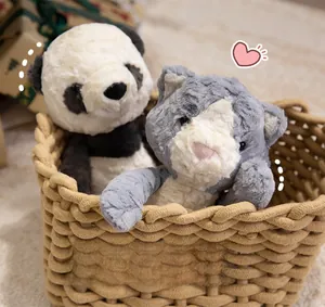 Close-up of soft plush panda and grey cat toys in a woven basket with warm lighting