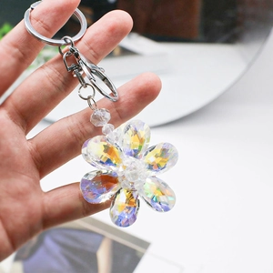 Handheld crystal flower keychain with vibrant rainbow reflections and metallic ring