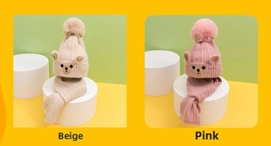 Detail of beige and dusty pink knit hat set with bear ears and fluffy pom poms
