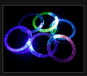Close-up of glowing LED bubble bracelets in vibrant colors on a dark background
