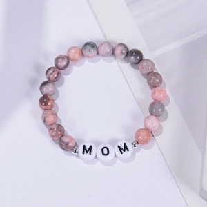 Detailed close-up of 8mm pink zebra stone bead bracelet with MOM lettering and metal accents