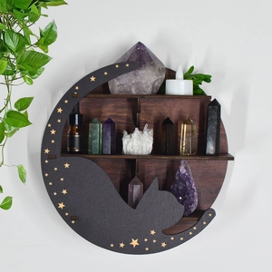 Detail of crescent moon wooden shelf with black cat silhouette and golden stars