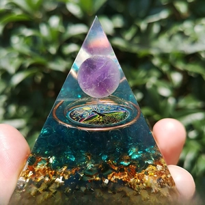 Detailed view of handmade Orgonite pyramid with Amethyst sphere and Tree of Life symbol