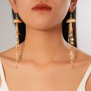 Detail view of jellyfish earrings with colorful beads and starfish tassels on a model