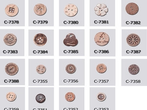 Macro detail of assorted handmade wooden buttons with engraved patterns in a grid layout