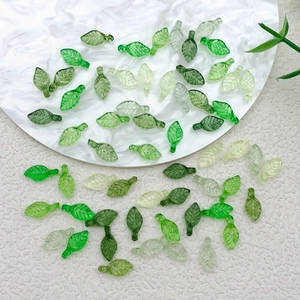 Macro view of multi-colored acrylic mini leaves for DIY handmade jewelry crafting