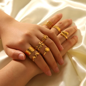Detailed view of 18K gold plated stainless steel ring set on beige silk background