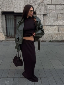Fashionable dark brown ribbed knit skirt set with a green leather biker jacket