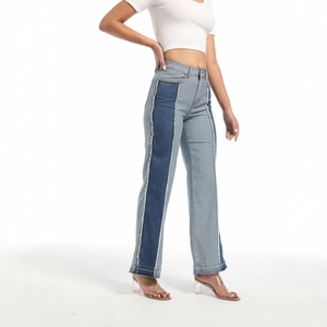 High-waisted patchwork denim jeans with contrast side panels and frayed raw hem edge