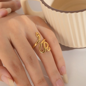 Close-up of elegant gold snake-shaped adjustable ring worn by model on finger