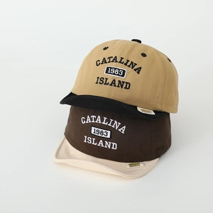 Close-up of retro baby baseball caps with 1983 embroidery and soft brim detail