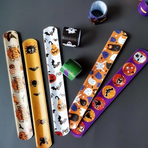 Flat lay of diverse Halloween snap bracelets with pumpkin, ghost, and bat patterns